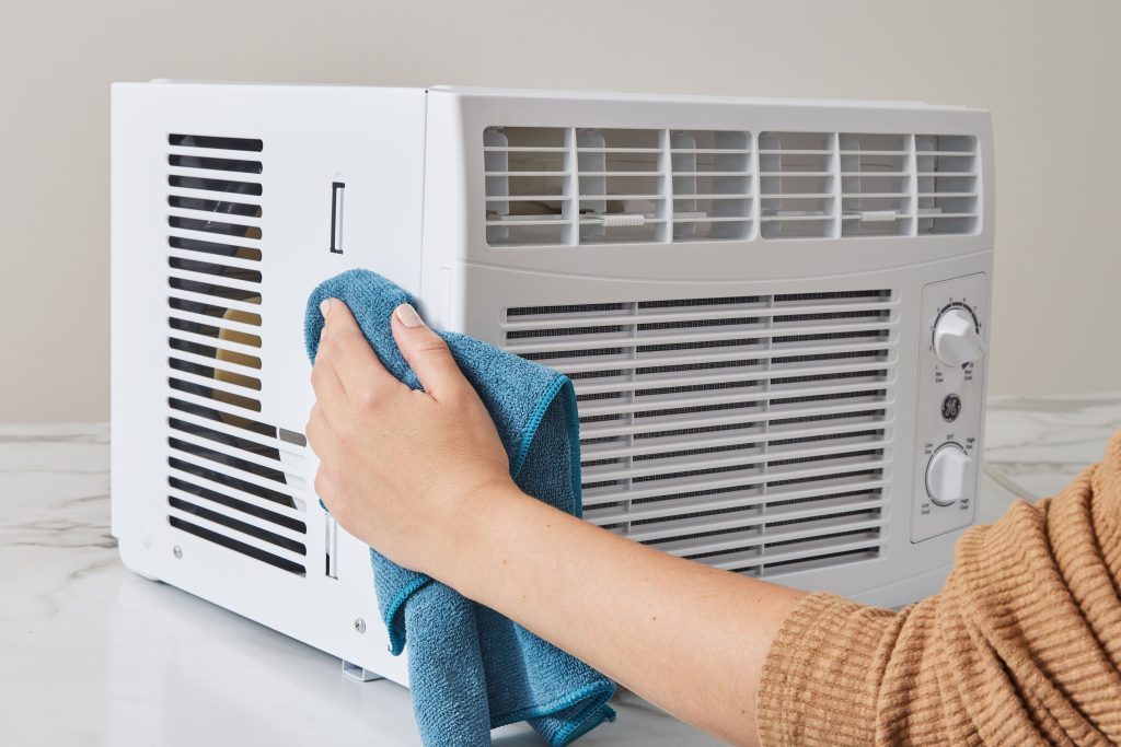the women is washing split air conditioner
